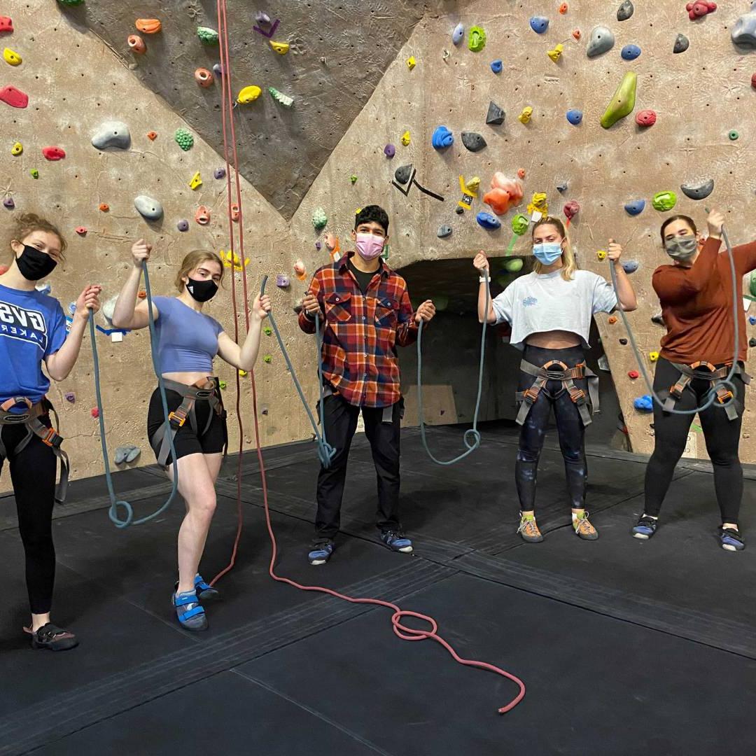 Image of five WIT peer educators at the climbing wall.